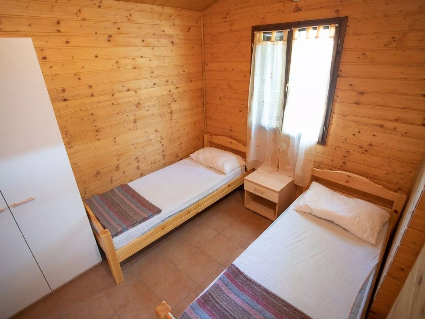 Bungalow aus Holz mit Veranda und nah am Strand.-Image-tags.info